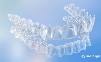 Invisalign clear aligner against sky blue background