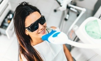 Woman getting in office teeth whitening from cosmetic dentist