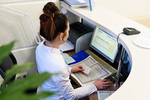 Receptionist working at a computer
