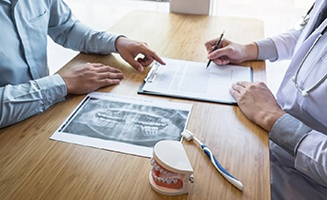 Dental patient signing a form