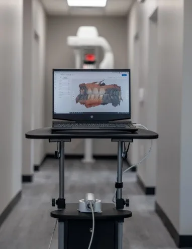 Digital impressions of teeth on computer screen in dental office hallway