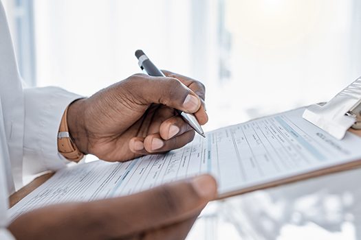 a patient filling out forms on a clipboard