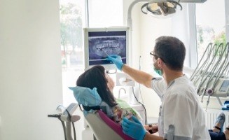 Dentist showing a patient x rays of their mouth