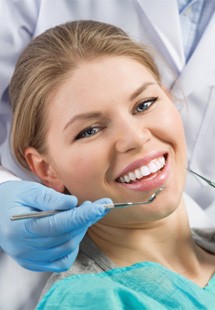 patient smiling while visiting dentist 