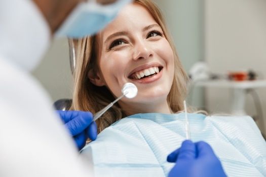 Woman smiling at her dentist during preventive dentistry visit