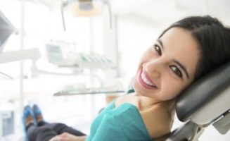Smiling brunette woman in dental chair