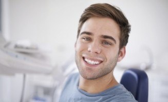 Young man smiling in dental treatment room
