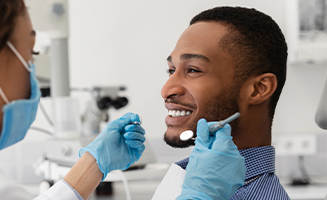 Man smiling at his dentist before dental exam