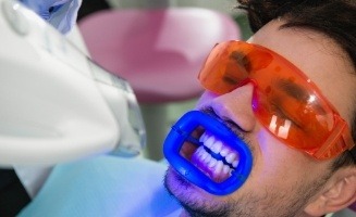 Man getting in office teeth whitening from cosmetic dentist