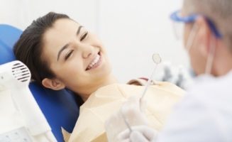 Young woman grinning at her dentist