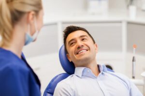 Man smiling at dentist after cosmetic dental treatment